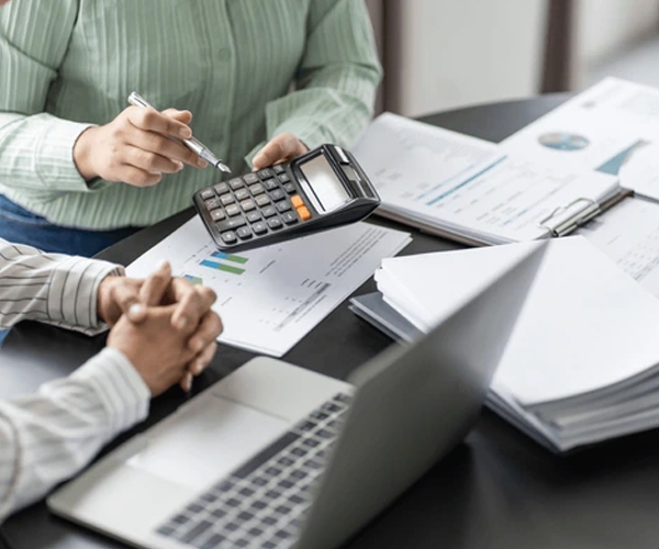 Bookkeepers with professionals reviewing accounts and reports