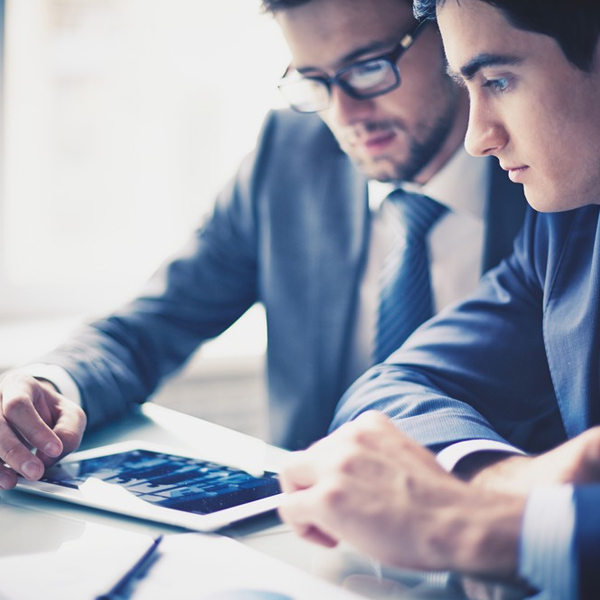 Two businessmen using a tablet for business advisory services