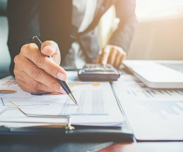 Payroll services with businessman reviewing financial reports and data