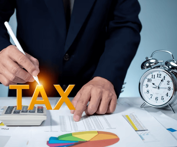 Tax return services with businessman using calculator and tax reports